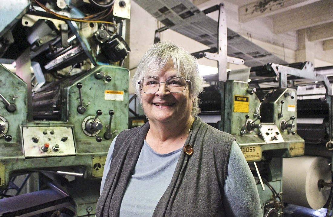 Louise Ronald was recently named Working Woman of the Year by the Winchester chapter of Business and Professional Women. Pictured above, the Graphic Printing Company president stands in front of the printing press at the company's headquarters in Portland. (The Commercial Review/Bailey Cline)