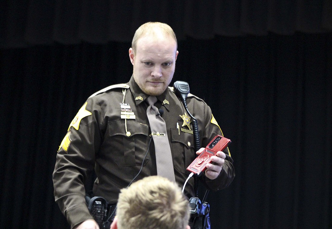 Derek Bogenschutz prepares for his presentation Wednesday at Jay County High School. The sergeant with Jay County Sheriff's Office shared information about the dangers of social media to children. (The Commercial Review/Bailey Cline)