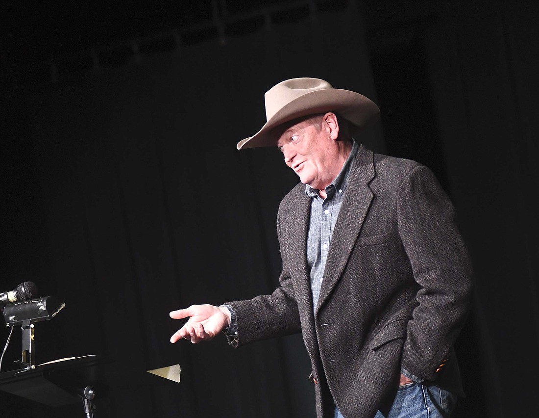 Craig Johnson, author of the Longmire series of novels, gestures while speaking to a large crowd gathered Thursday night at Arts Place for his visit hosted by Jay County Public Library. In addition to the presentation at Arts Place, after which he signed books for those in attendance, Johnson visited the library earlier in the day. (The Commercial Review/Ray Cooney)