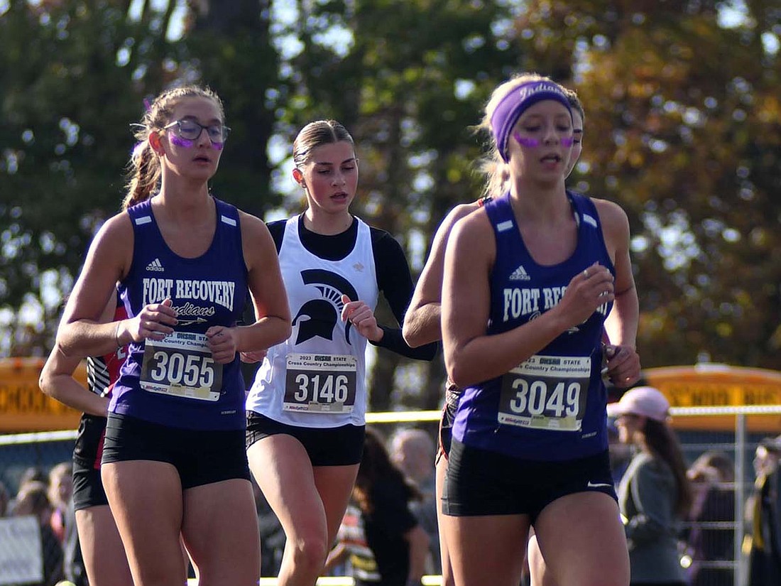 Fort Recovery High School freshman Makenna Huelskamp (3049) leads a pack of runners including senior Ellie Will (3055) as they approach the two-mile mark at the OHSAA State Championship at Fortress Obetz and Memorial Park on Saturday. (The Commercial Review/Andrew Balko)