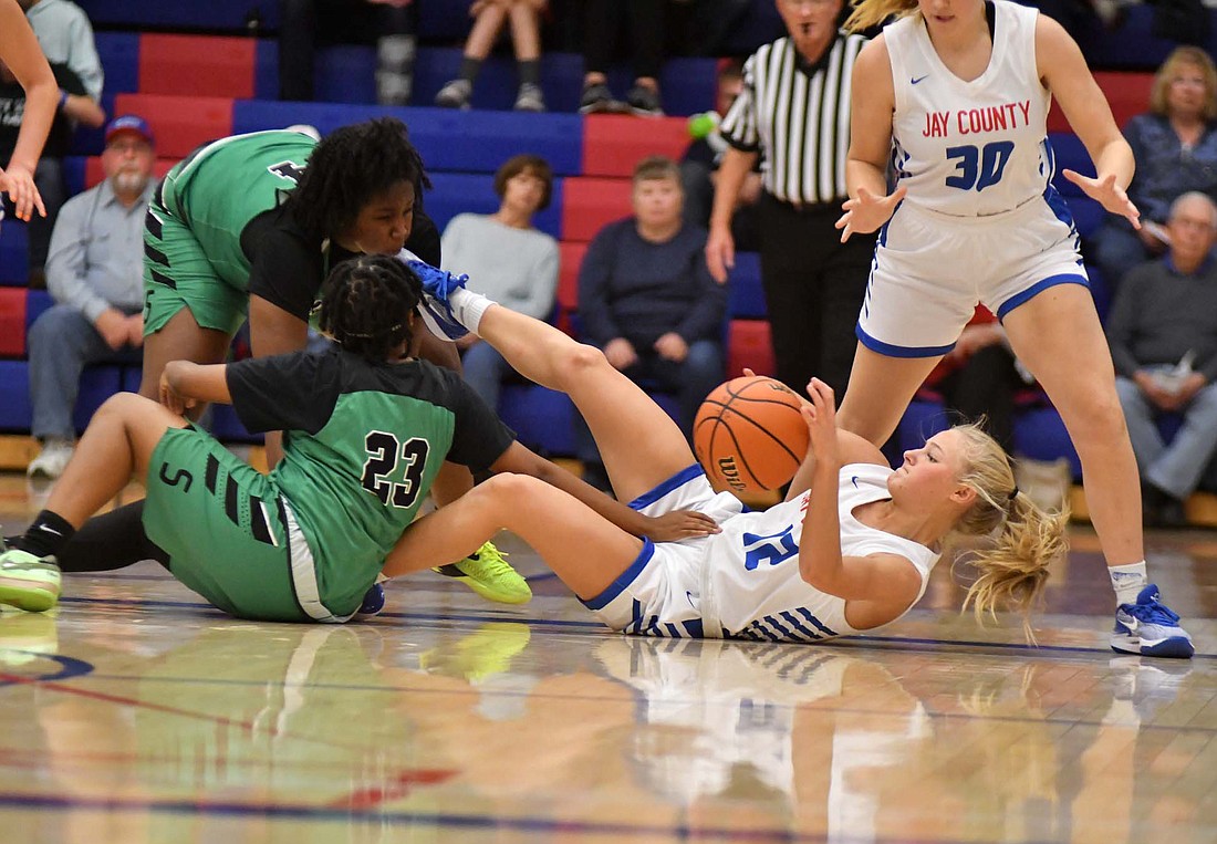 Jay County High School freshman guard Hallie Schwieterman (12) dives on the floor for a loose ball in the Patriots’ 60-35 win over South Side in Tuesday’s season opener. Schwieterman led the Patriots with 20 points and six steals in her varsity debut. (The Commercial Review/Andrew Balko)