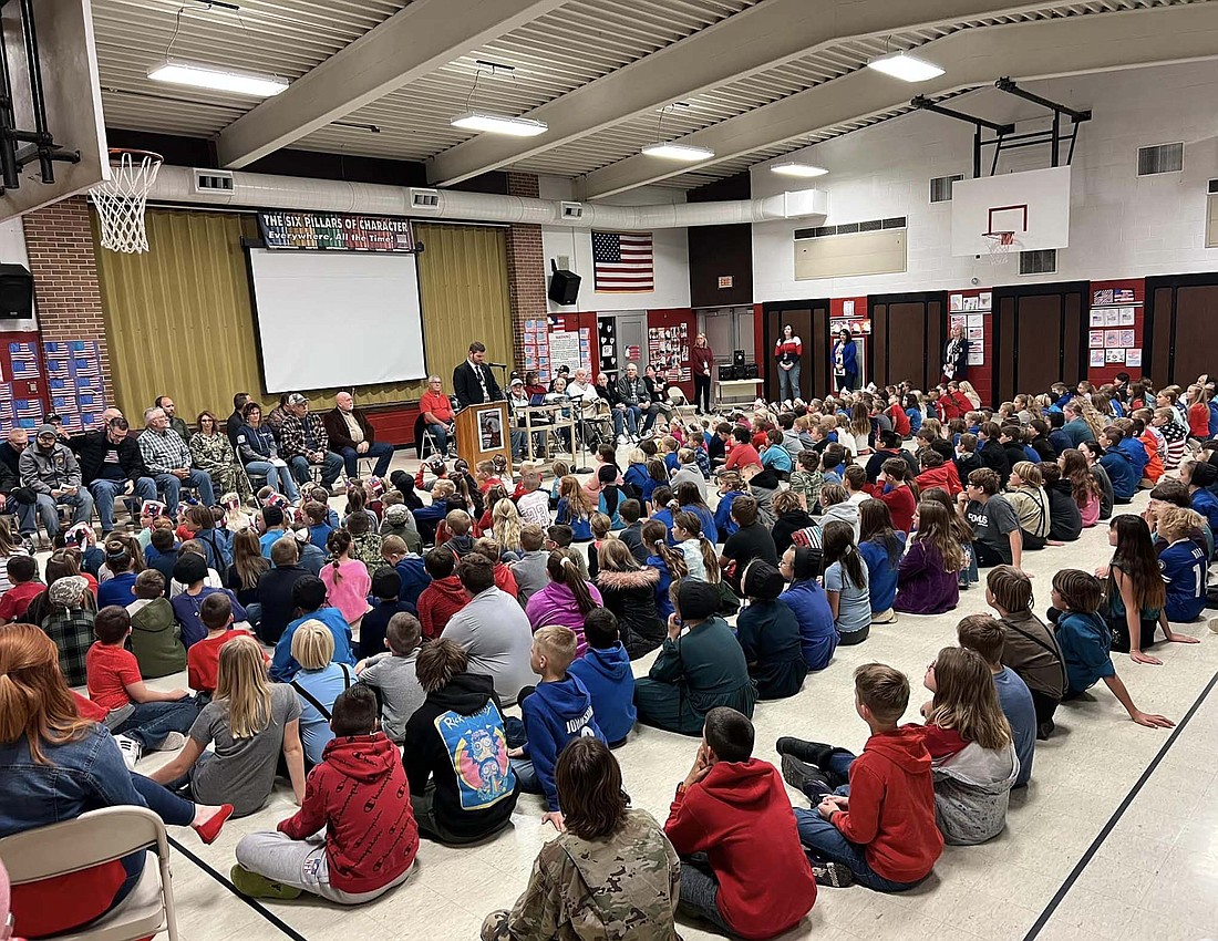 Local schools honored veterans with ceremonies Thursday and Friday. Pictured above, Bloomfield Elementary School principal Ben Dues speaks while flanked by veterans in attendance. (Photo provided)