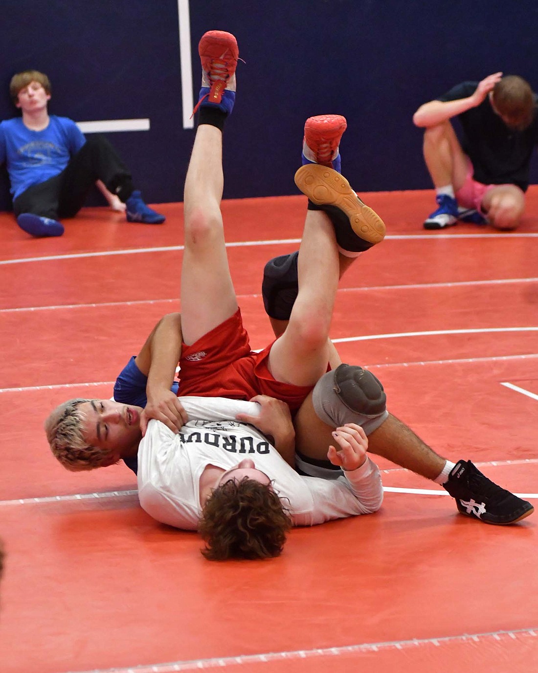 Jay County High School’s Tony Wood (behind) and Jacob Robinson (front) demonstrate a far wrist tilt during practice on Thursday. The JCHS boys wrestling team just started practices last week and are preparing for the season opener against Centerville on Nov. 28. (The Commercial Review/Andrew Balko)