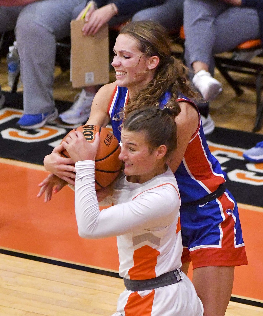 Molly Muhlenkamp of Jay County High School and Ella Hickok of Hamilton Heights fight over a loose ball during Saturday evening’s basketball game. The Patriots fell 53-41 to drop the sixth consecutive game against the Huskies. (The Commercial Review/Andrew Balko)