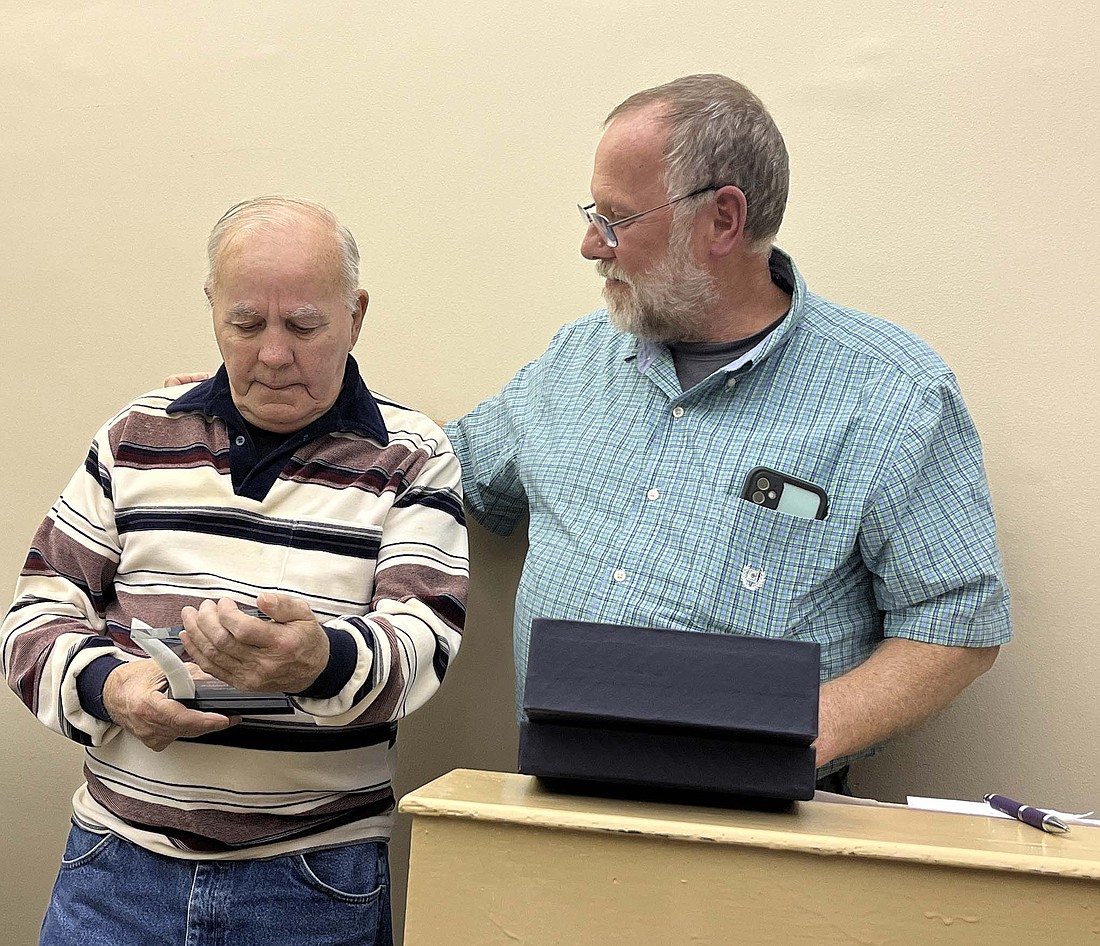 Dunkirk City Council president Jesse Bivens (right) presented awards to outgoing council members Tom Johnson, Bryan Jessup and Kevin Hamilton at the conclusion of Monday’s meeting. Pictured, he puts his arm around Johnson, who got a bit emotional after being presented his award for more than two decades of service. After receiving the plaque, Johnson announced that he learned earlier in the day that he is now cancer-free. (The Commercial Review/Ray Cooney)