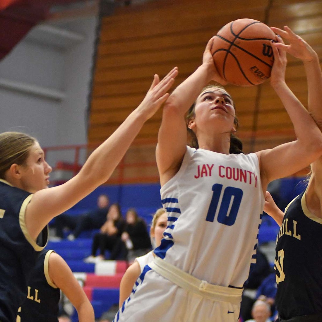 Sophie Saxman of Jay County High School fights through contact on a layup during the Patriots' 38-15 win over Oak Hill on Tuesday. Saxman was 4-for-8 from the stripe in the game while leading Jay County in steals and rebounds. (The Commercial Review/Andrew Balko)