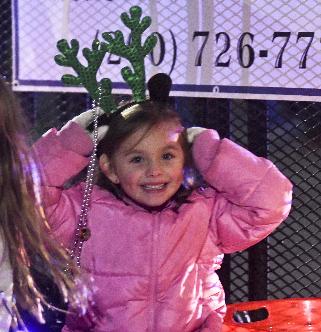 Winterfest activities Saturday included the Kids Breakfast and Karnival, Little Miss Winterfest Pageant and Parade of Lights. Pictured above, Murphy Ellis adjusts her antlers while riding on a float during the parade Saturday evening in downtown Portland. Below, Nash Loden, 4, Portland, plays the penguin race game during the Karnival at East Jay Elementary School. (The Commercial Review/Ray Cooney)