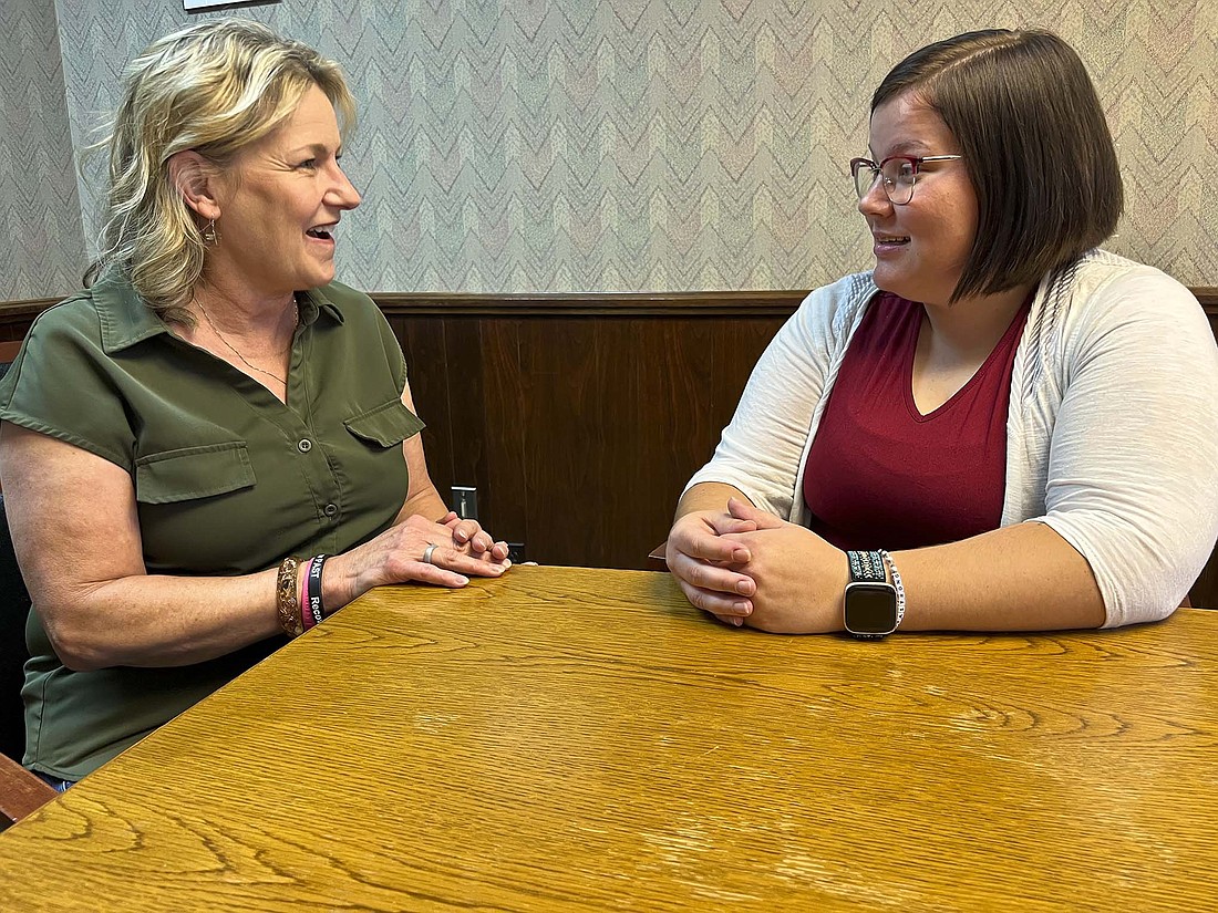 Jay County Drug Prevention Coalition Peer Addiction Support Team (PAST) director Ally Raines (right) talks with Kimbra Reynolds, executive director of the coalition. Raines, who celebrated five years drug-free in October, took over as PAST director in July. “I think being in recovery, you’re constantly working on yourself,” she said. “Today, five years into it, I still work on things in my life … But I also have a healthy support system now.” (The Commercial Review/Louise Ronald)