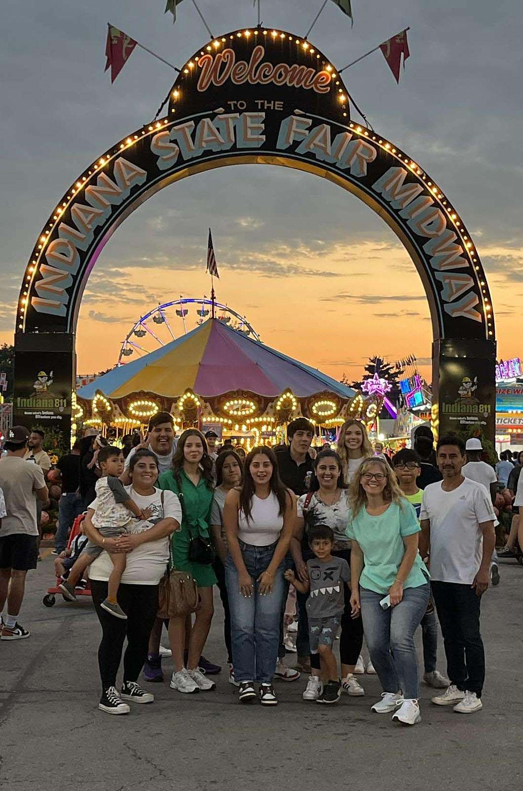 Lucie Henneaux of Belgium, fourth from left, with her host family and friends at the Indiana State Fair. Henneaux lives with Bobby and Cheryl Ruiz of Portland. (Photo provided)