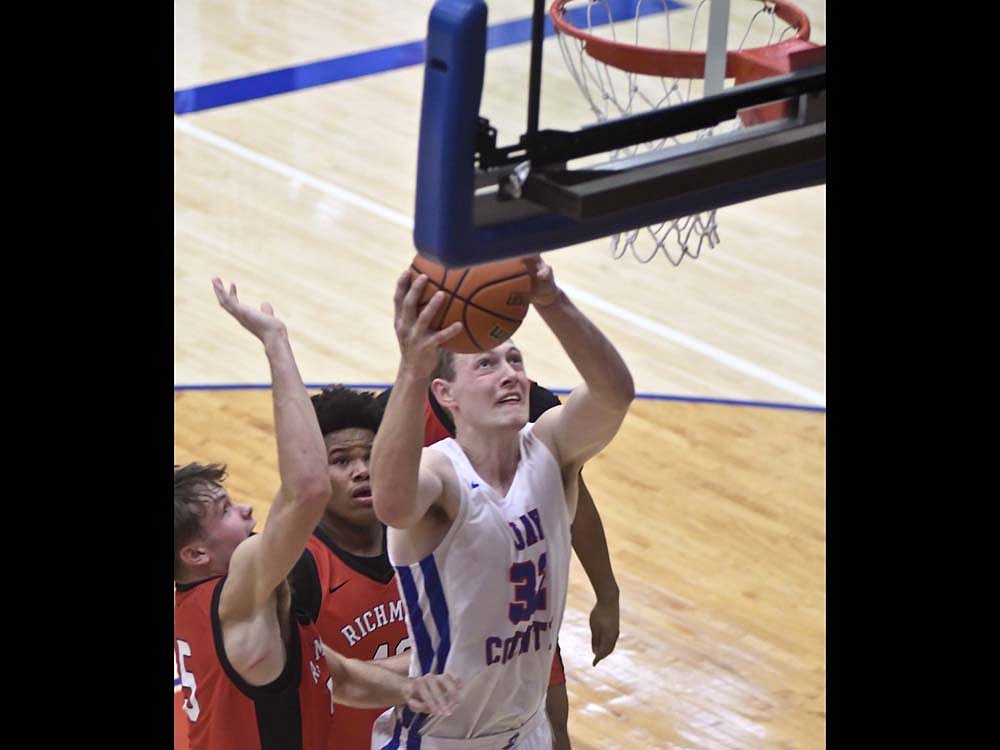 Wesley Bihn of Jay County High School puts a shot up in front of a trio of Richmond defenders during the second quarter Saturday. The Patriots went more than 16 minutes without a field goal as they suffered their worst loss in nearly four years. (The Commercial Review/Ray Cooney)