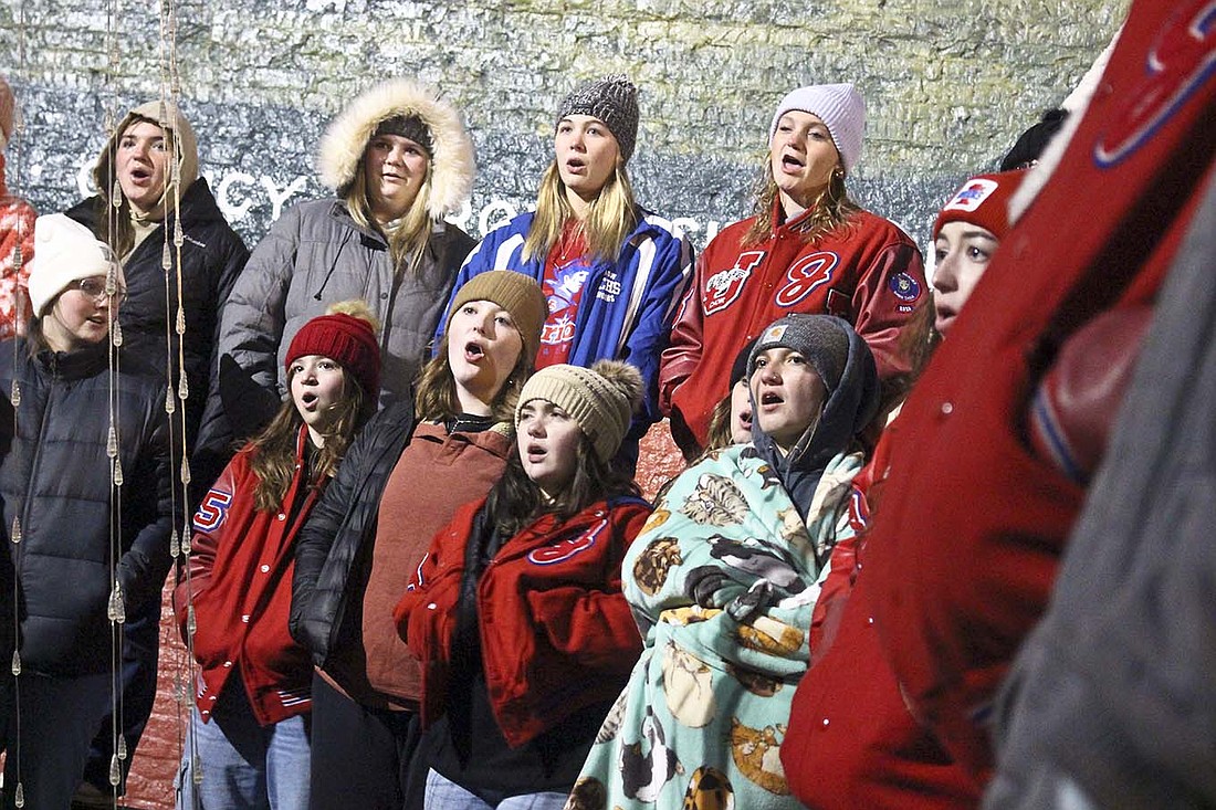 Jay County High School choir members sing while staying bundled up Monday during Dunkirk’s Feel the Warmth of Christmas celebration. The low on Monday reached a chilly 21 degrees at night, with temperatures stuck at 32 degrees or colder throughout the day. (The Commercial Review/Bailey Cline)