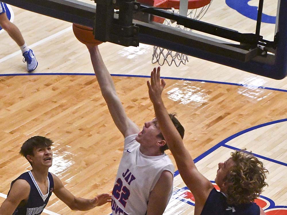 Ben Crouch (22) finishes a layup in the second quarter Friday as Jay County High School opened Allen County Athletic conference play with a 55-42 victory. (The Commercial Review/Andrew Balko)