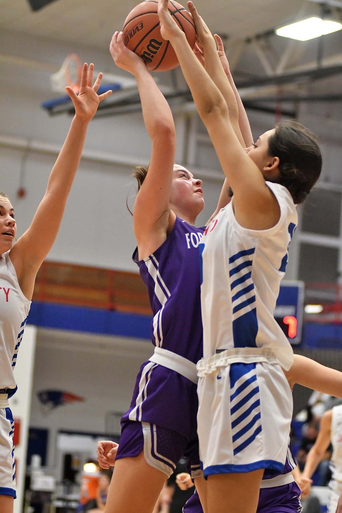 Jay County High School’s Natalie Carreno (right) blocks Saige Leuthold (shooting) of Fort Recovery in the first half of the girls basketball game on Saturday. The Patriots took the game 44-30 by speeding up the Indians and forcing 26 turnovers. (The Commercial Review/Andrew Balko)