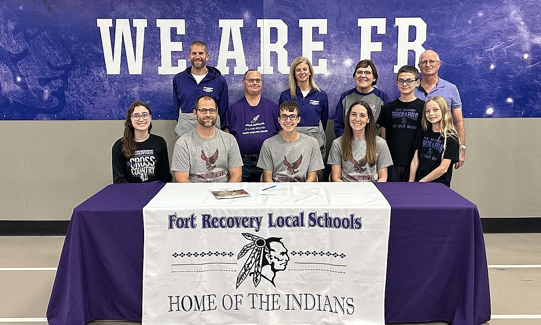 Fort Recovery High School's Trevor Heitkamp signed his letter of intent on Nov. 21 to run at Roberts Westlyan University in New York. Pictured seated from left are Aubrie Heitkamp, father Bob, Trevor and mother Laura. Standing are assistant coach Matt Roessner, Tim Heitkamp, coach Christy Diller, Kathy Heitkamp, Gavin Heitkamp, Tom Heitkamp and Elise Heitkamp. (Photo provided)