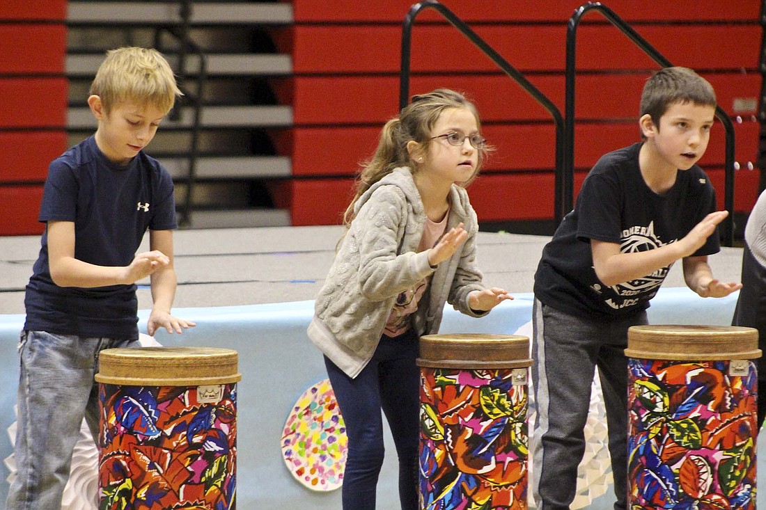 Bloomfield Elementary third graders Jaxson Mumby, Kazlynn Morehous and Isaac Rosenbeck beat on drums during their practice Christmas program session Tuesday morning at East Jay Elementary School. (The Commercial Review/Bailey Cline)