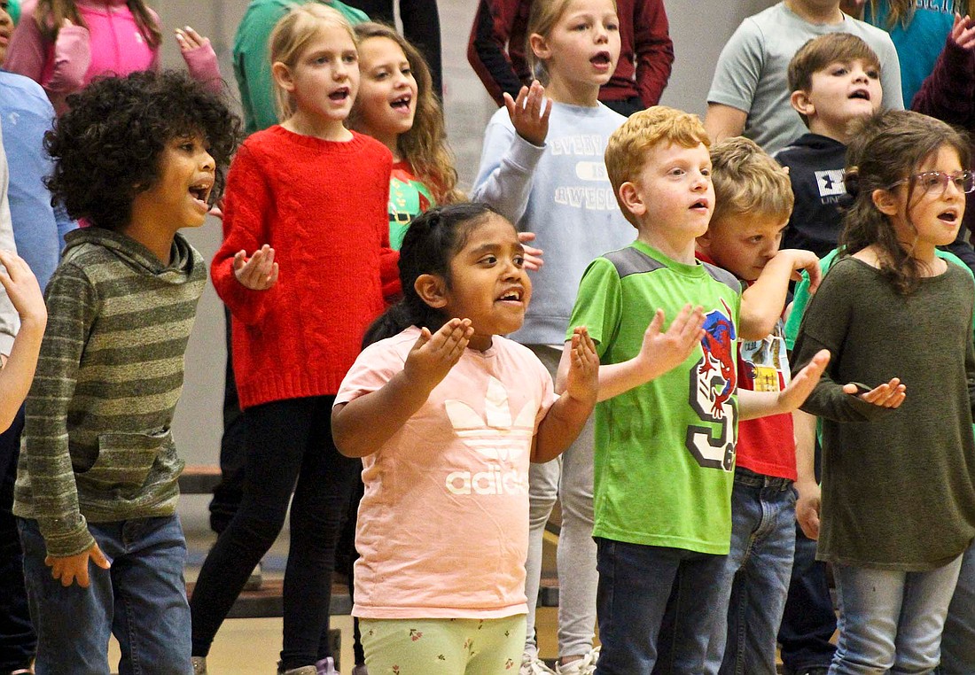 East Elementary second graders Maverick LeMaster, Allison Navaro-Garcia, Archer Nichols and Emree Spoonemore sing “We Wish You A Merry Christmas” at the end of their practice session. (The Commercial Review/Bailey Cline)