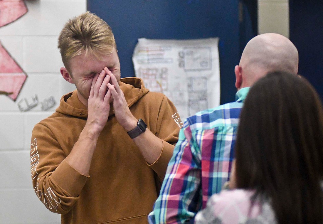 Gage Sims wipes tears from his eyes while getting hugs from family after he was surprised Thursday afternoon with the announcement that he is this year’s The Portland Foundation Community Scholar. The Jay County High School senior will receive tuition and room and board for the Indiana College of his choice, as well as a stipend for books. (The Commercial Review/Ray Cooney)