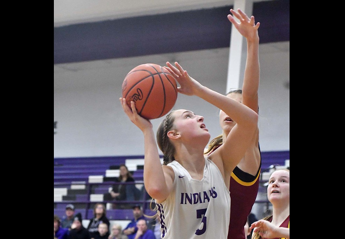 Fort Recovery High School's Karlie Niekamp finishes an up-and-under move when she got New Bremen's Chloe Homan off the ground in the first half of the Indians' 40-29 loss Thursday. (The Commercial Review/Andrew Balko)