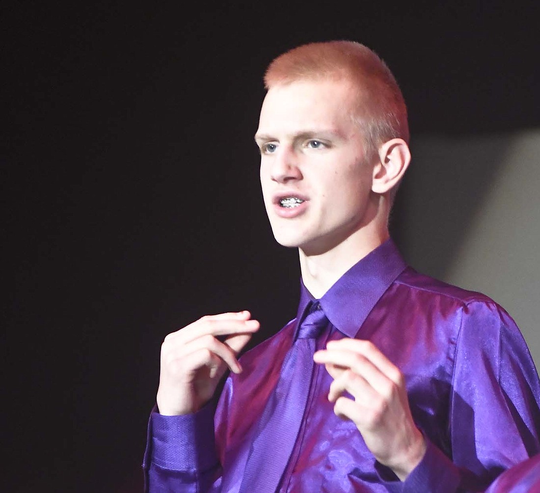 Andy Niekamp of the Fort Recovery junior high choir snaps his fingers during Sunday’s Choral Christmas Concert. The junior high choir’s selections were “A Holly Jolly Christmas” and “Like It’s Christmas.” (The Commercial Review/Ray Cooney)