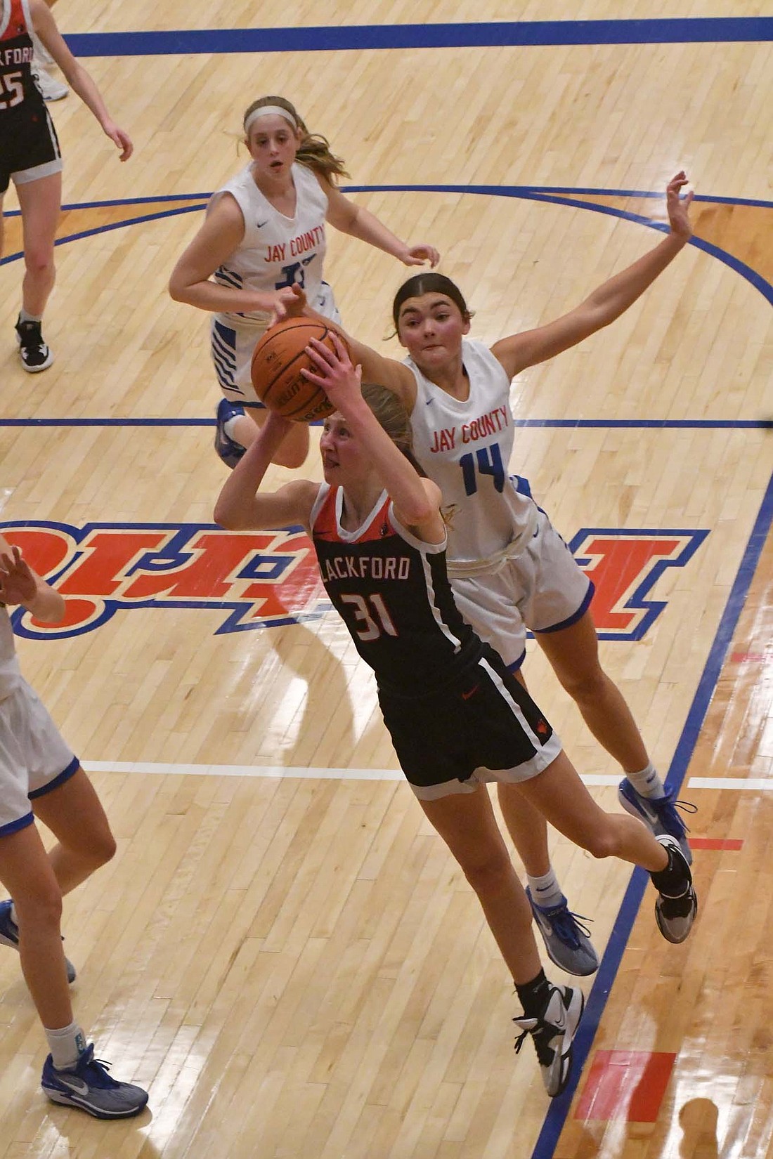 Jay County's Meredith Dirksen blocks Blackford's Sydnee Morris from behind during the Patriots' 47-32 win over the Bruins. Stout defense powered JCHS to the victory, holding Morris to only three points in the game. (The Commercial Review/Andrew Balko)