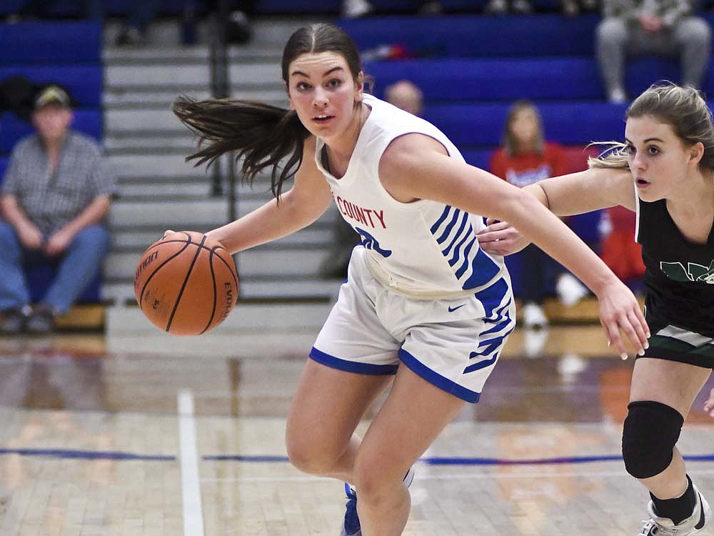 Jay County High School senior Sophie Saxman dribbles past Kaidyn Minyard of New Castle during the Patriots’ 63-24 victory Thursday. Saxman led JCHS with 13 points, shooting 4-of-5 from the field and 5-of-6 from the foul line with five rebounds and three assists. (The Commercial Review/Ray Cooney)