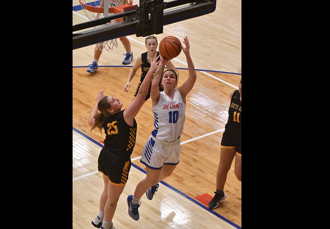 JCHS senior Sophie Saxman puts up a second-chance bucket on Saturday during the Patriots' 67-39 blowout of South Adams. Saxman scored a career-high 19 points and was busy on the glass with nine offensive rebounds. (The Commerical Review)