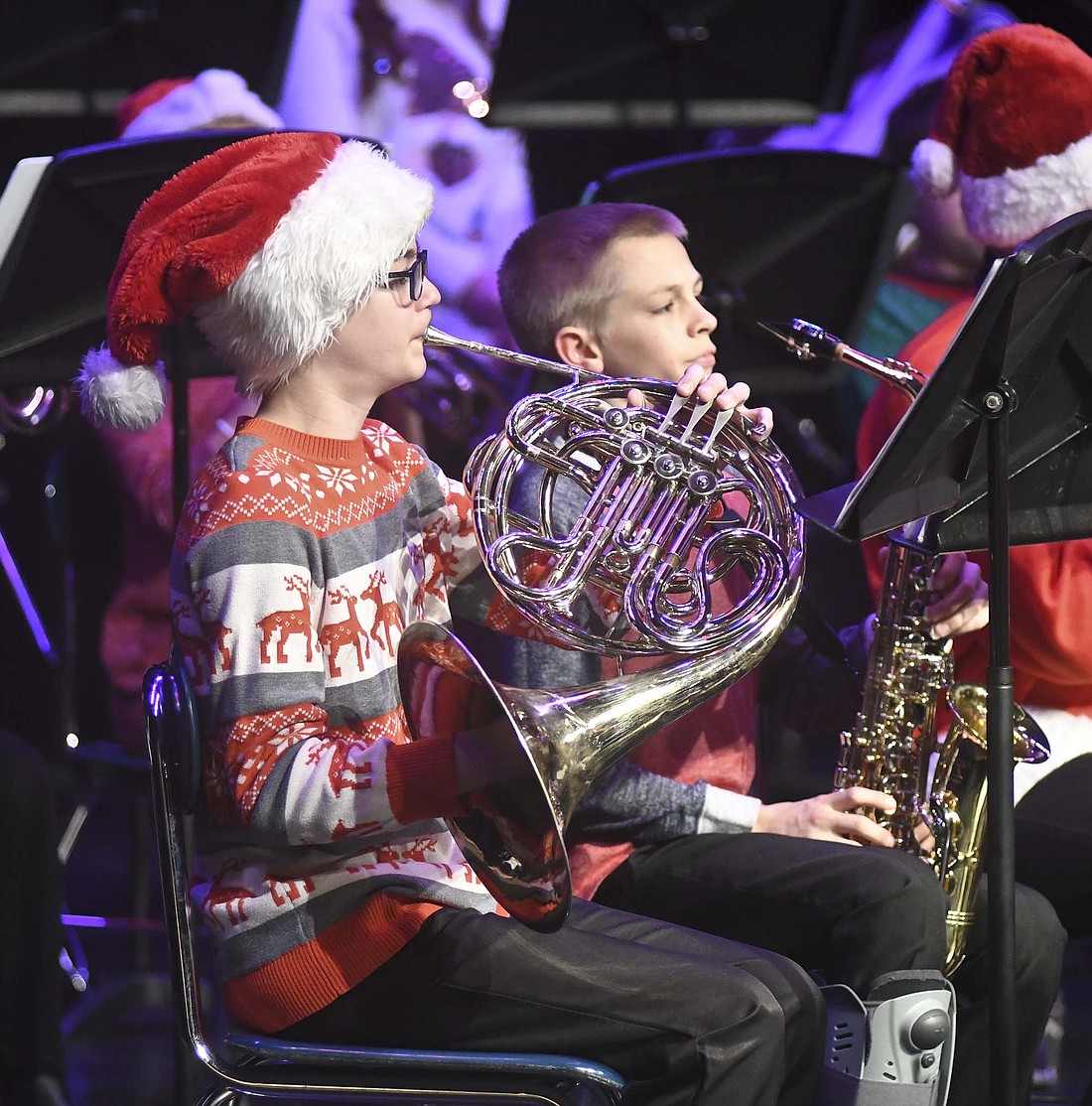 Seventh grader Gavin Heitkamp plays the French horn Sunday as part of the middle school band during the Fort Recovery Local Schools Christmas band concert. (The Commercial Review/Ray Cooney)