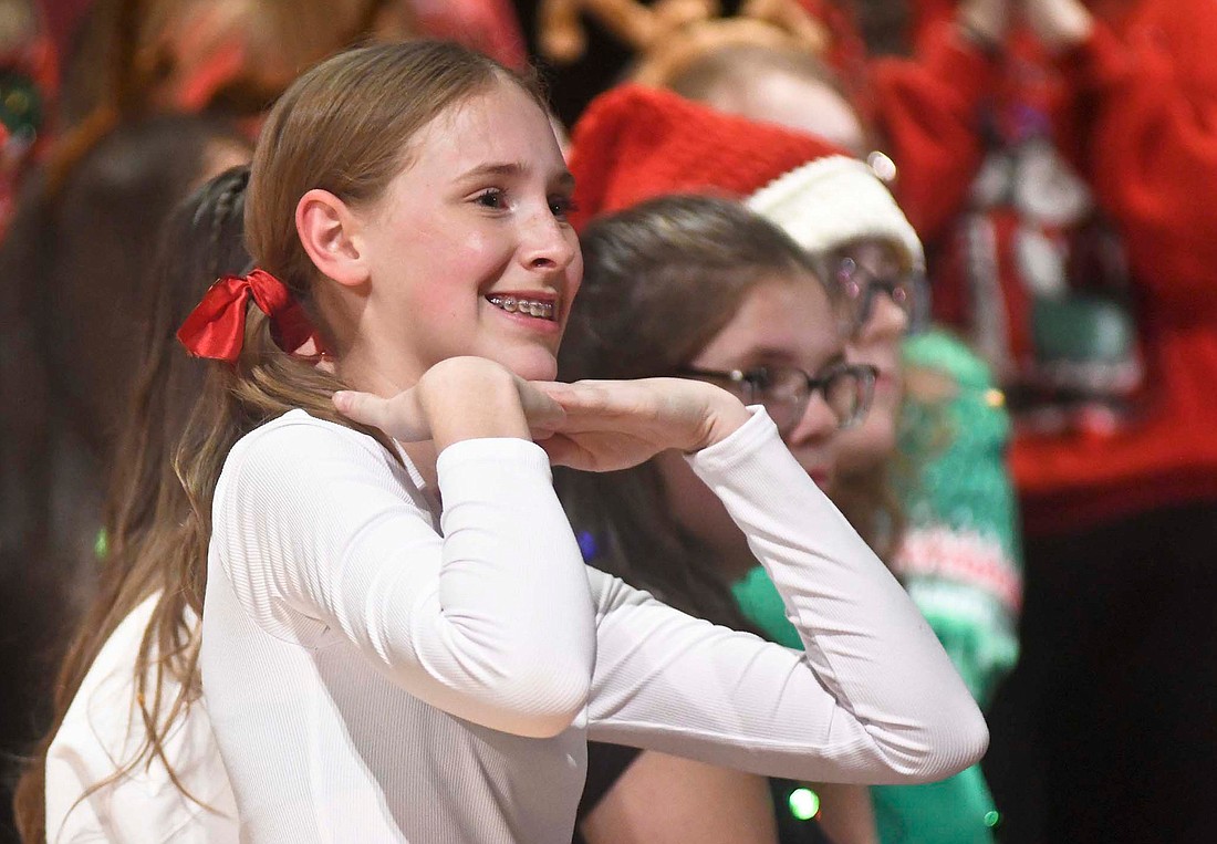 Izzy Huelskamp poses Tuesday at the conclusion of the Jay County Junior High School choir’s production of “Lights! Camera! Christmas!” Huelskamp played Student Isobel in the show that featured the songs “Super Santa,” “Mary, Did You Know?” and “Get Along, Little Reindeer.” (The Commercial Review/Ray Cooney)