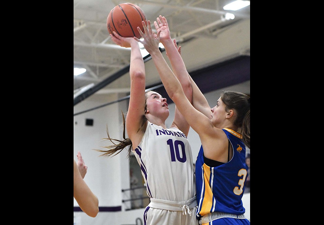 Fort Recovery High School senior Saige Leuthold (10) takes contact from St. Marys Memorial's Syerra Gerber on a shot attempt during the 34-31 loss on Tuesday. Leuthold scored a season-high 11 points on 5-for-6 shooting. (The Commercial Review/Andrew Balko)