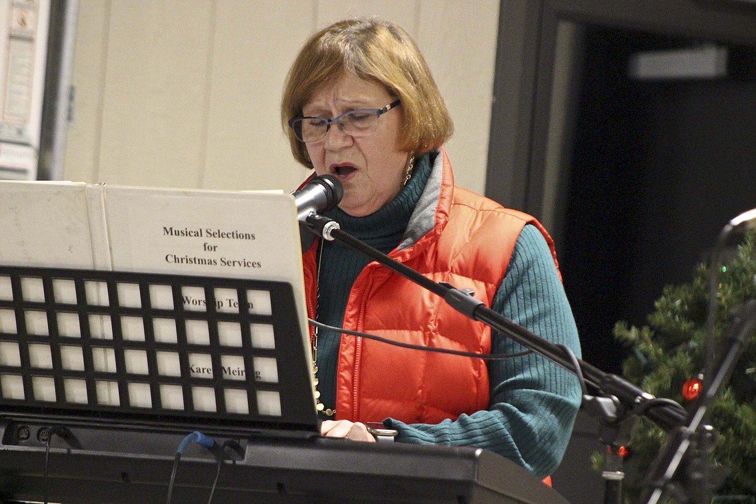 Karen Meiring sings “Move Me Closer” during Fort Recovery Radio’s Christmas Gala broadcast Wednesday at Cooper Brothers Community Pavilion in Community Park. The broadcast brought in more than $202,000 — more is expected to come in via mail in the coming weeks — that will be distributed to various local families and causes. (The Commercial Review/Bailey Cline)