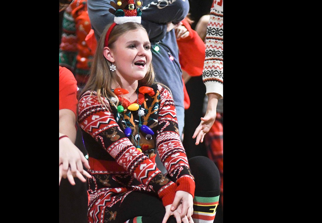 Seventh grader Kylee Timmerman sings Tuesday evening during  the Jay County Junior High School choir’s production of “Lights! Camera! Christmas!” Timmerman played Student Greta in the show that featured the songs “Super Santa,” “Mary, Did You Know?” and “Get Along, Little Reindeer.” (The Commercial Review/Ray Cooney)