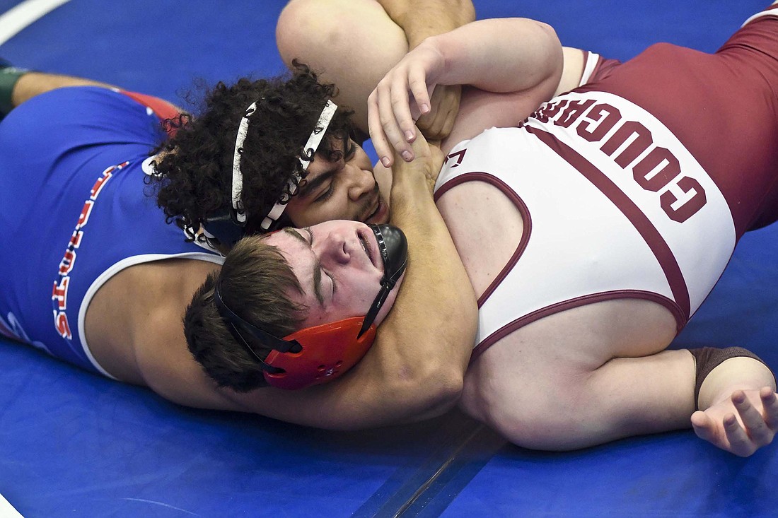 Juaquin Flores of host Jay County High School puts the pressure on Parker Boots of Central Noble on Friday during the East Central Indiana Classic. Flores was one of six Patriots to earn championships with pins in the final round — he beat New Castle’s Nathan Shafer in 2 minutes, 39 seconds, for his title — as Class 2A No. 4 JCHS earned the ECIC team title for the third consecutive year. (The Commercial Review/Ray Cooney)