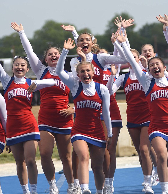 Jay County High School cheerleaders, including seniors Karci Hopkins and Cash Hollowell (center), cheer and celebrate as they leave the mat Aug. 5 during the Indiana State Fair cheerleading competition. Also pictured, from left, are Hina Ohba, Emmarie Barton and Moa Sakamoto.  (The Commercial Review/Ray Cooney)
