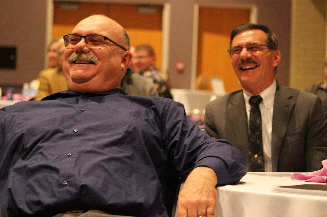 Dave and Jerry Kaup laugh at jokes presented by Ed Hosbach at the Fort Recovery Chamber of Commerce awards banquet March 12. (The Commercial Review/Bailey Cline)
