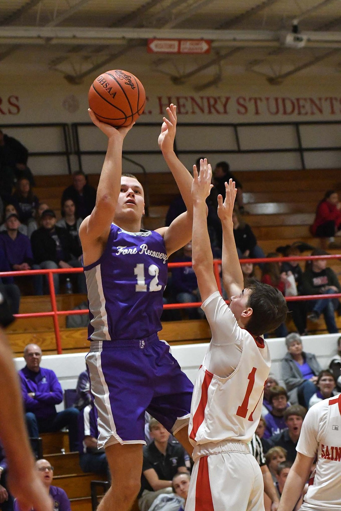 Fort Recovery High School senior Rex Leverette rises up for a jump shot in the Indians’ 53-40 loss at St. Henry on Friday. (The Commercial Review/Andrew Balko)