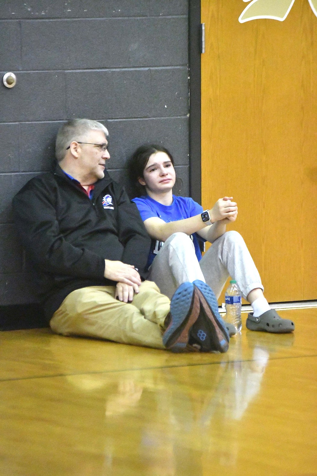 Jay County High School assistant wrestling coach Troy Jacks chats with Katie Rowles after the seventh-ranked Patriot suffered a tough 4-3 loss to No. 6 Angelica Clay of Lakeland during the ticket round of the semi-state tournament Friday at Rochester. A win in the match would have sent Rowles to the state finals. Three Patriots — semi-state champion Mallory Winner, Emily Manor and Lina Lingo — went on to earn berths in the state finals, which will be contested Friday at Kokomo. (The Commercial Review/Andrew Balko)