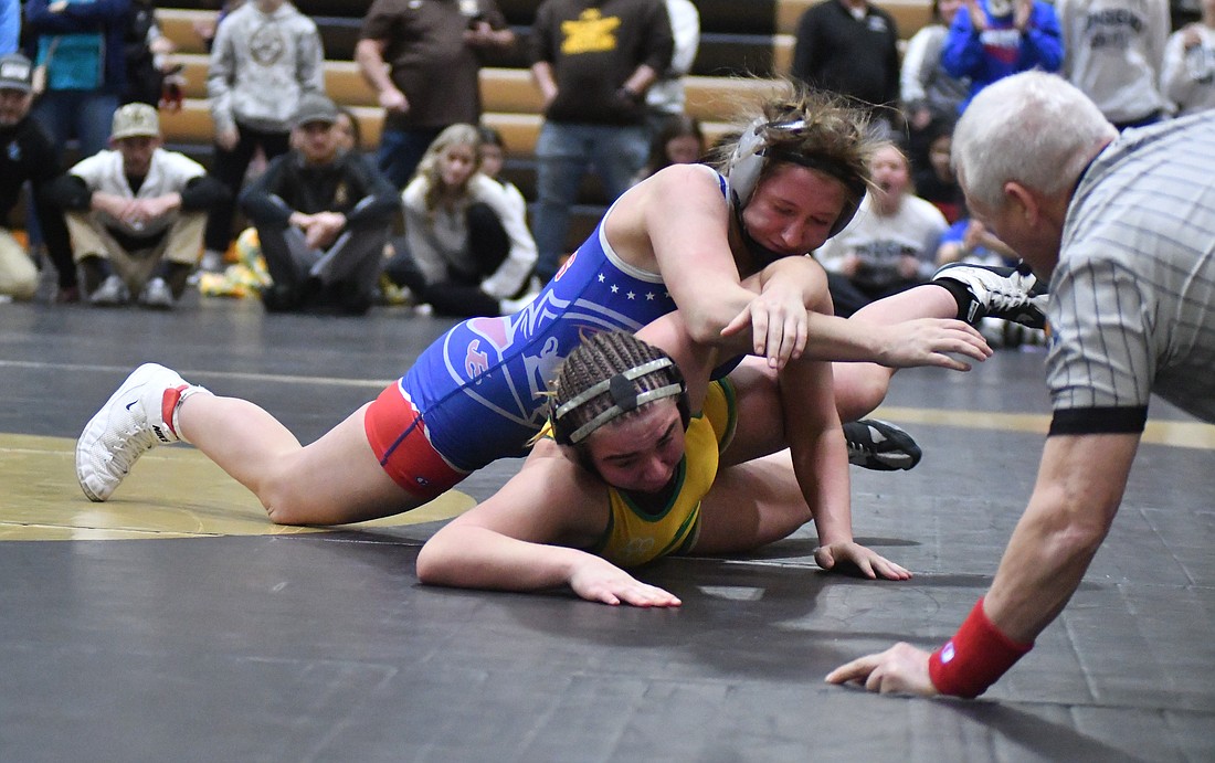 Top-ranked Mallory Winner of Jay County battles against No. 2 Rhaigyn Trenary of Eastside during the 155-pound championship match Friday at the semi-state tournament hosted by Rochester. Winner, a two-time defending state champion, went back and forth with Trenary before getting a late takedown to lock up a 9-6 victory. (The Commercial Review/Andrew Balko)