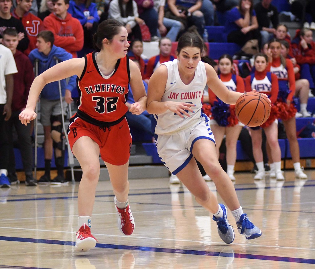 Jay County High School senior Sophie Saxman drives past Madyson Sonnigsen of Bluffton during the Patriots’ 40-24 win Friday. Saxman celebrated Senior Night in style with a career-high 20 points and game-high eight rebounds. (The Commercial Review/Ray Cooney)