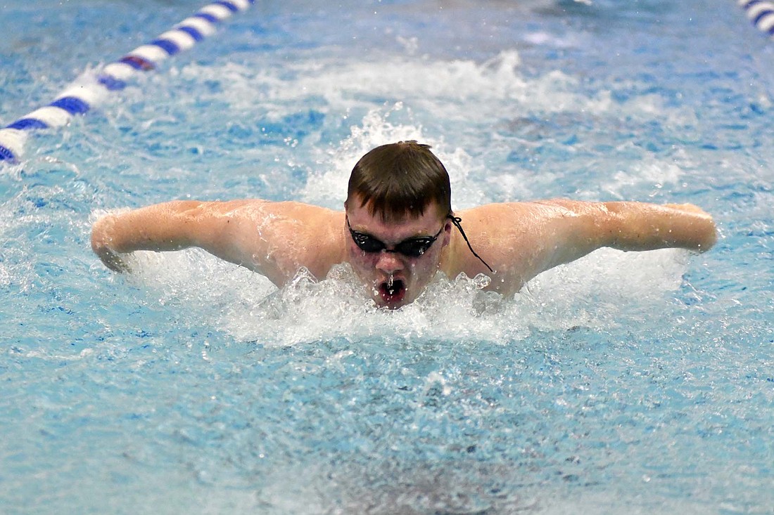 JCHS sophomore David Keen breaches the surface while swimming the 100-yard butterfly on Thursday. Keen finished third in the race as the Patriot boys split by defeating Coldwater but falling to Celina. (The Commercial Review/Andrew Balko)