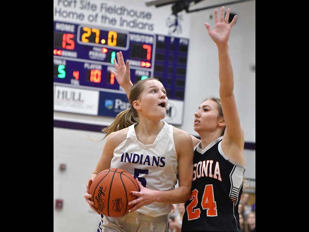 FRHS senior Cali Wendel draws contact from Ansonia’s Bailey Schmit during the Indians’ 51-36 blowout on Tuesday. Wendel hit both free throws as part of a 24-0 Indians run. (The Commercial Review/Andrew Balko)