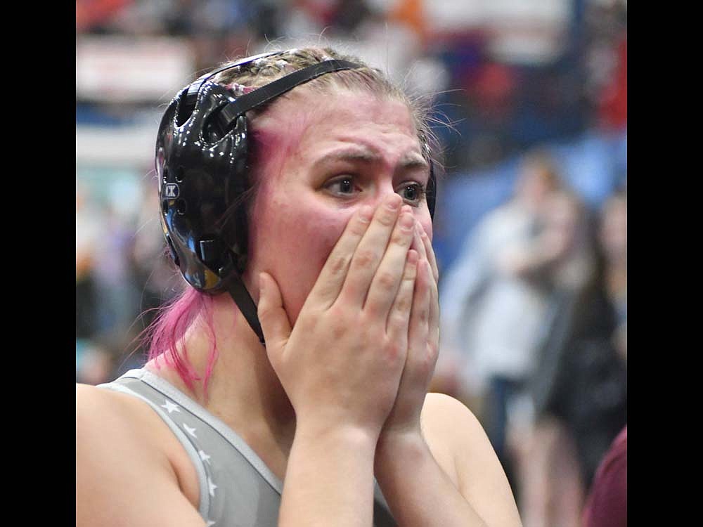 Lina Lingo of Jay County High School clasps her hands over her face after winning the 135-pound opening match over No. 9  Klaire Redwine on Friday during the Indiana High School Girls Wrestling state finals at Kokomo to clinch her first state medal. Lingo, a junior, went on to upset the second-ranked wrestler in the state en route to a fourth-place finish while her classmate Mallory Winner won her third consecutive state championship. (The Commercial Review/Andrew Balko)