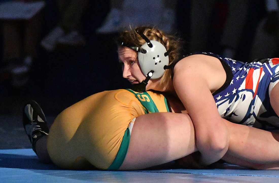 Jay County High School junior Mallory Winner holds No. 2 Rhaigyn Trenary to the mat during the 155-pound championship match during the Indiana High School Girls Wrestling State Finals on Friday at Kokomo High School. Time expired as Winner held Trenary in place to win 6-0 and capture her third state title. She breezed through the first three rounds of the state finals, needing just over six minutes to dispose of No. 15 Sophia Rygiel (11-9) of Greenwood, No. 8 Kate McKee (29-10) of Perry Meridian and No. 3 Josie Hause (23-5) of Monrovia all by pin. (The Commercial Review/Andrew Balko)