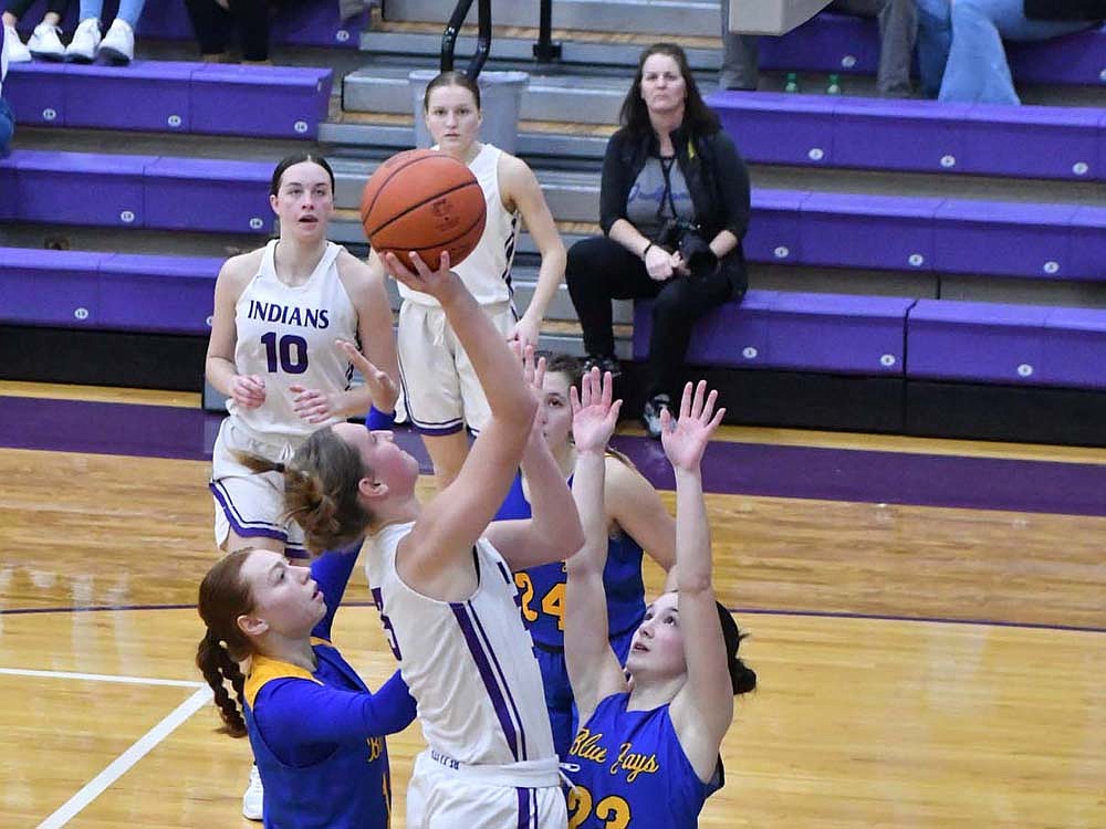 Fort Recovery senior Karlie Niekamp blows past Bluejay’s sophomore Ava Hershey on for a layup as Megan Kerner (23) slides underneath to try and take a charge on Thursday. Niekamp recorded a double-double with 16 points and 10 rebounds in the 63-53 victory over St. John’s. (The Commercial Review/Andrew Balko)