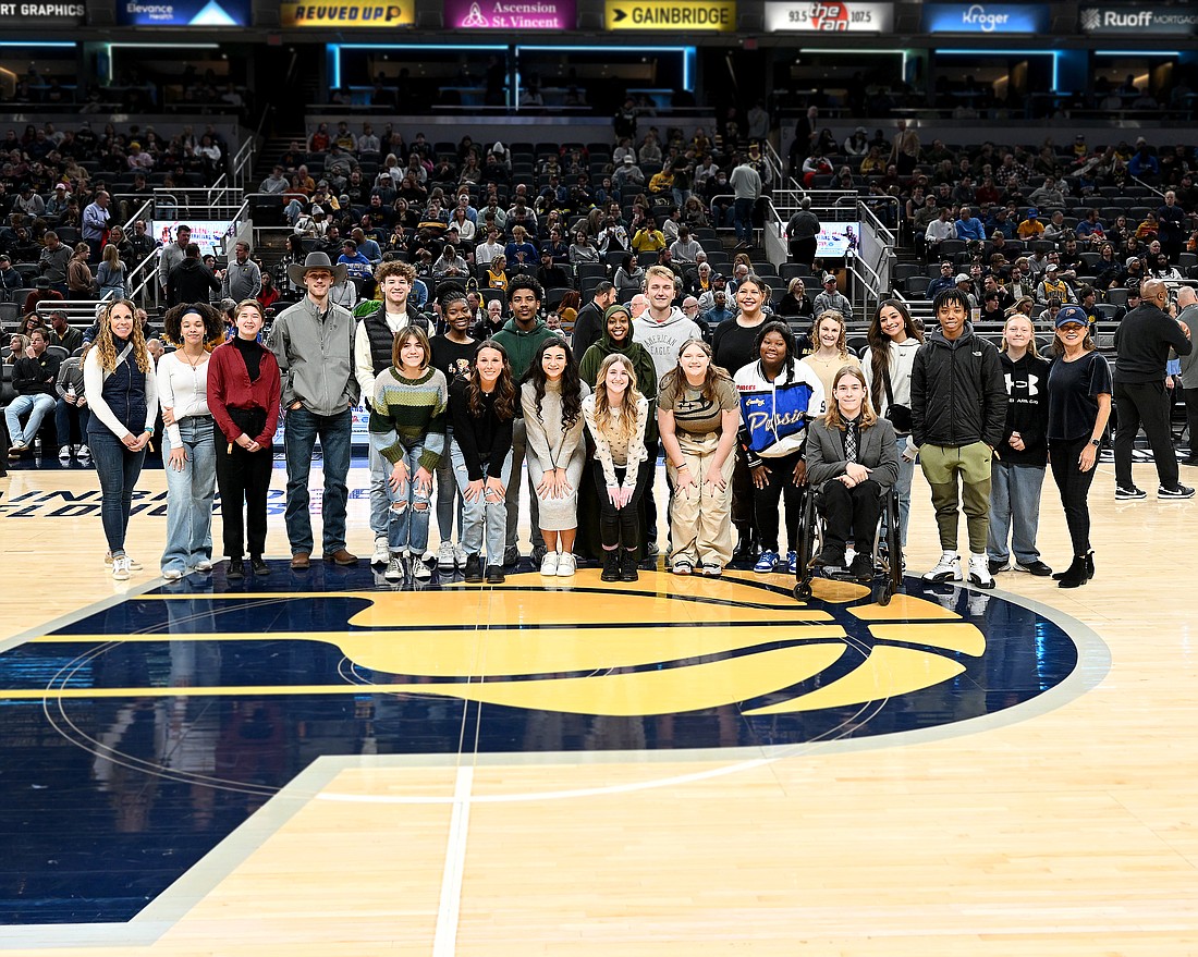 Twenty of the 24 students of the 2024 graduating class selected by the Indianapolis NBA All-Star 2024 Host Committee as NBA All-Star Legacy Grant Rising Stars were recognized at the Indiana Pacers game on Wednesday, Jan 3, against the Milwaukee Bucks. Gage Sims (middle back row in a gray sweatshirt), a senior at Jay County High School, was chosen as one of the recipients of the $2,400 scholarship. (Photo provided)