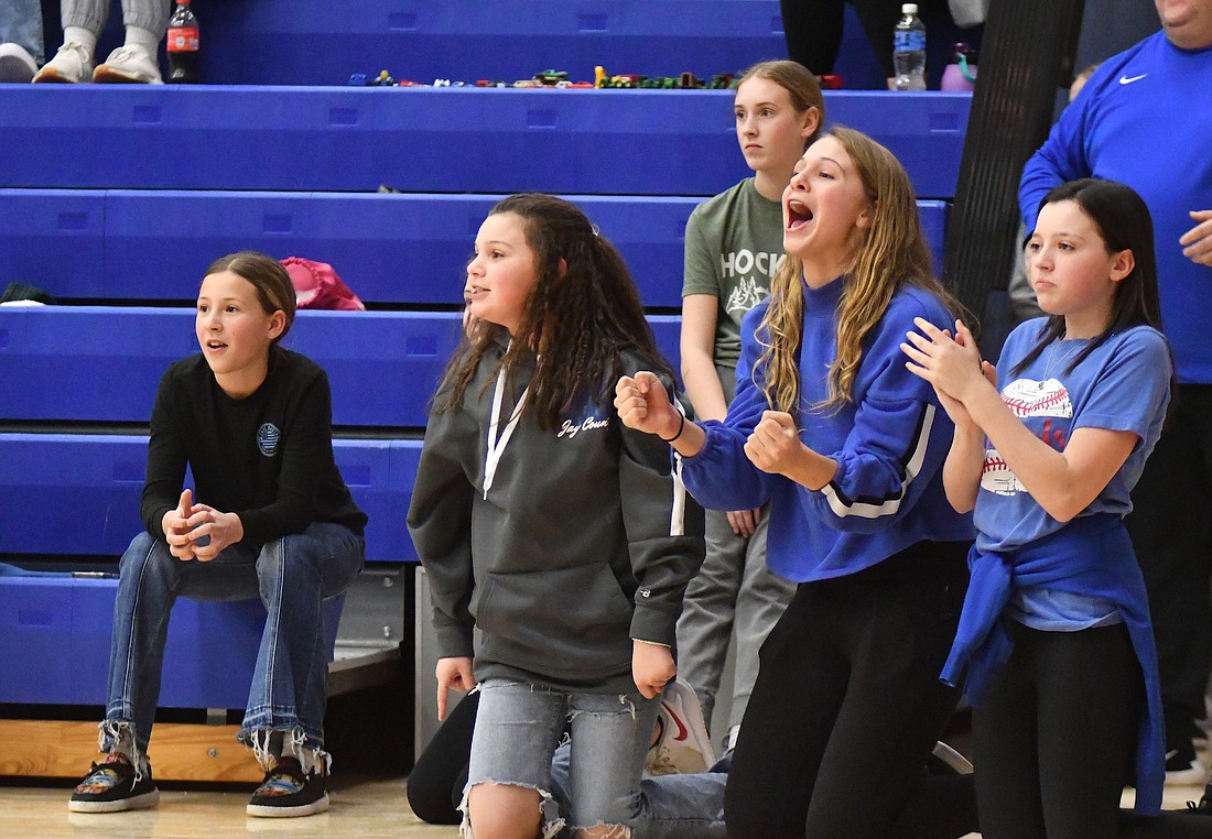 Kendall Farr, Kendall Schemenaur and Makenzie Farr cheer on their friend Emery  Forthofer during a game of knockout during halftime of the Jay County High School boys basketball game on Friday. Forthofer was knocked out by Daisy Muhlenkamp, who won and will get to play knockout at the NBA All-Star game at Gainbridge Fieldhouse on Feb. 18. (The Commercial Review/Andrew Balko)