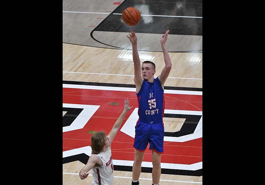 Jay County High School’s Gradin Swoveland rises over Elijah Garrett of Bluffton early in the second quarter on Friday night. Swoveland hit the three to score the first points for the Patriots, who were scoreless in the first quarter but went on to win 31-14. (The Commercial Review/Andrew Balko)