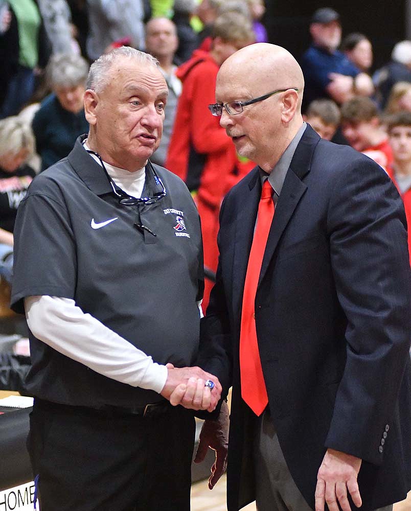 Jay County coach Jerry Bomholt (left) and Bluffton coach Craig Teagle (right) shake hands following Jay County's 31-14 win Friday night. Bomholt and Teagle — the winningest coach in JCHS history who also led the Patriots to the 2006 Class 3A state championship game — are fifth and 15th among current head coaches in wins in the state of Indiana. (The Commercial Review/Andrew Balko)