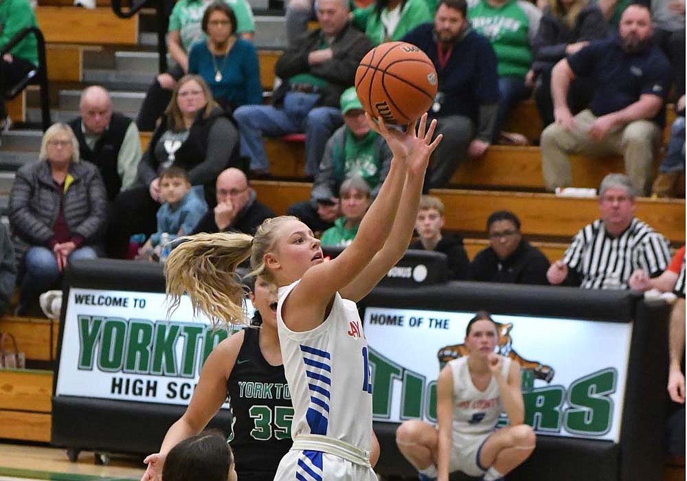 Hallie Schwieterman, a freshman on the Jay County High School girls basketball team, pulls the trigger on a jump shot from the elbow during the Patriots’ 56-48 victory over host Yorktown in the sectional opener Tuesday. Coach Sherri McIntire was pleased with the freshman’s 13 points and eight rebounds in her postseason debut.(The Commercial Review/Andrew Balko)