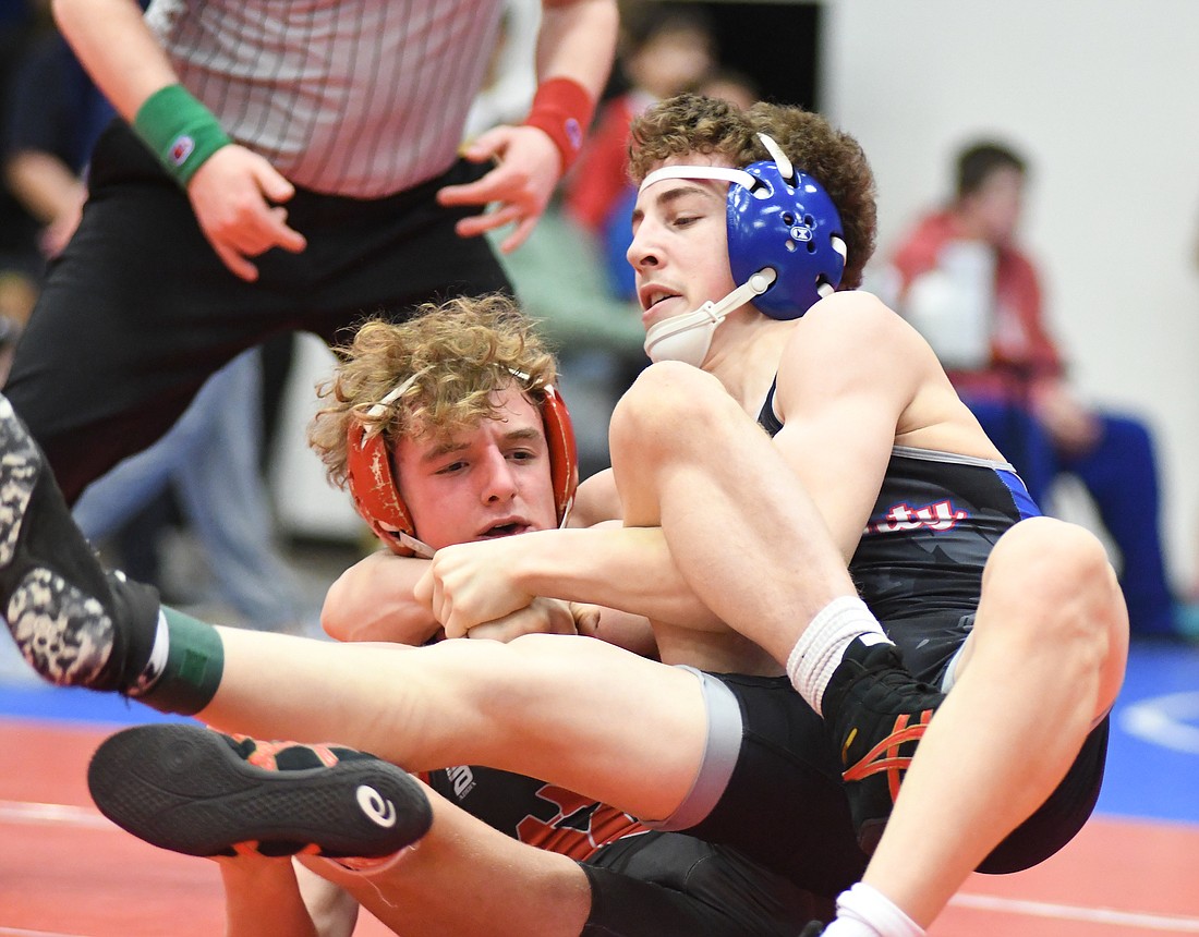 A.J. Heskett, a Jay County High School junior, wraps Adams Central’s Brason Schortgen in a cradle during the 132-pound championship match in Saturday’s sectional tournament. Heskett lost to Schortgen by a 23-8 technical fall. By finishing in second place, he will be one of nine Patriots who will compete in the regional tournament beginning at 8:30 a.m. Saturday at JCHS. (The Commercial Review/Ray Cooney)