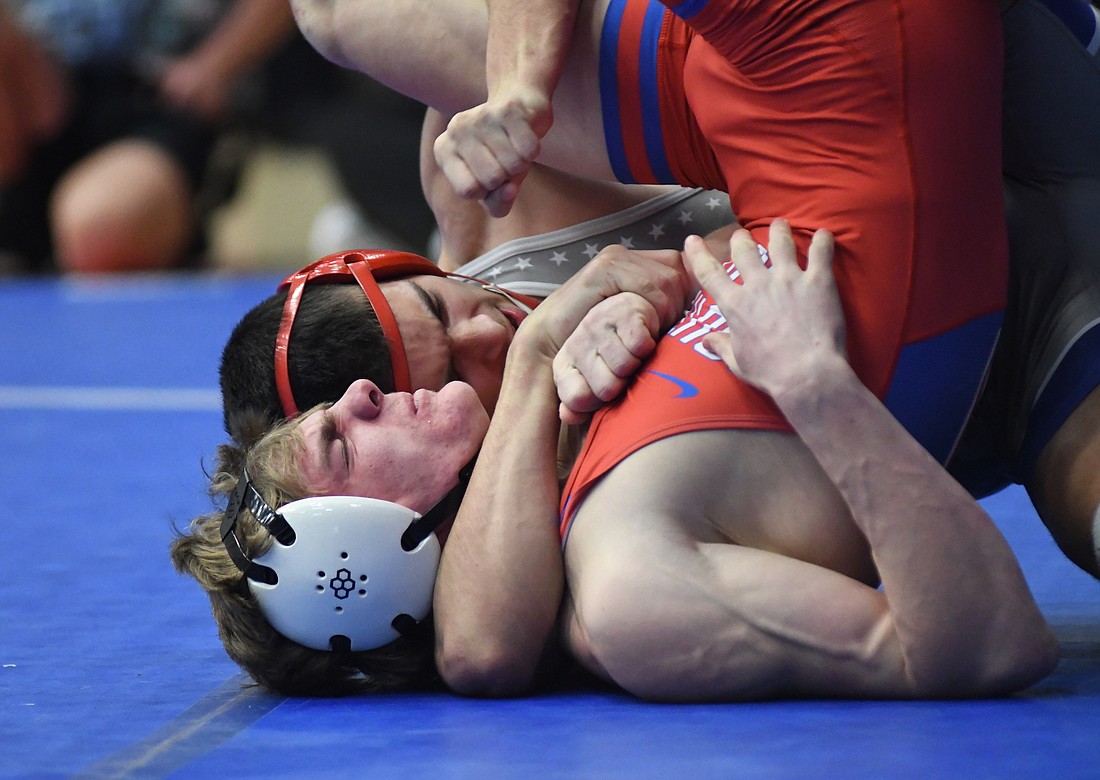 Jay County High School's Tony Wood pins Jarin Frauhiger (30-9) of Southern Wells during their regional semifinal match Saturday. Wood, who is undefeated and ranked fifth in the state, went on to pin Yorktown's No. 9 Justin Boone (31-2) in the finals to became the Patriots' first four-time wrestling regional champion. (The Commercial Review/Ray Cooney)